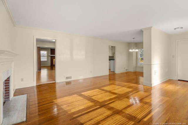 1905 N Rowland Ave N, Lumberton, NC 28358 - unfurnished living room with a chandelier, wood finished floors, and a fireplace