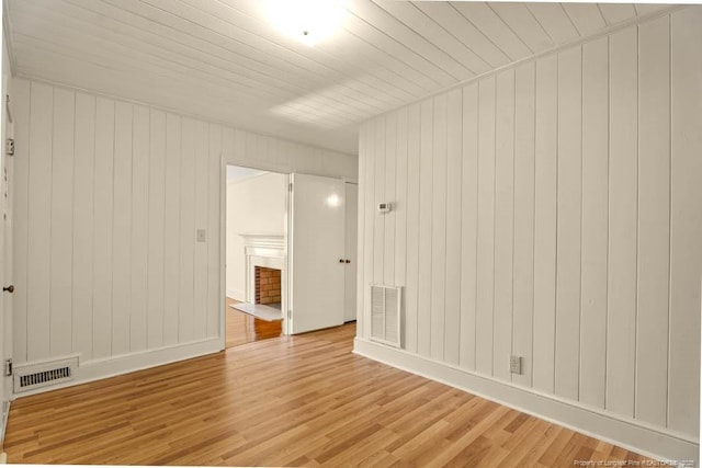 1905 N Rowland Ave N, Lumberton, NC 28358 - spare room with light wood-style floors and wooden walls