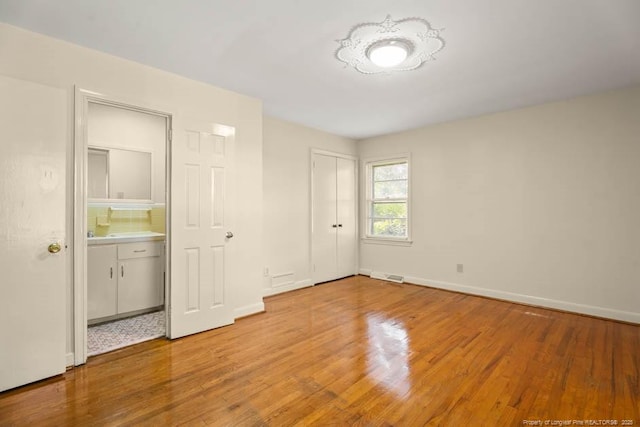 1905 N Rowland Ave N, Lumberton, NC 28358 - unfurnished bedroom featuring light wood-type flooring and baseboards