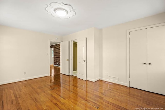 1905 N Rowland Ave N, Lumberton, NC 28358 - unfurnished bedroom with wood finished floors and a closet