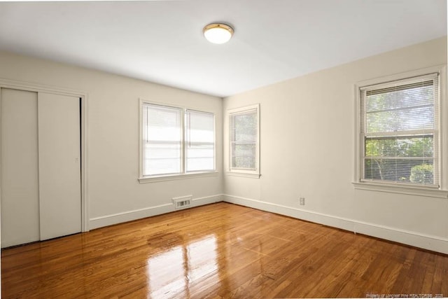 1905 N Rowland Ave N, Lumberton, NC 28358 - unfurnished bedroom with wood finished floors and a closet