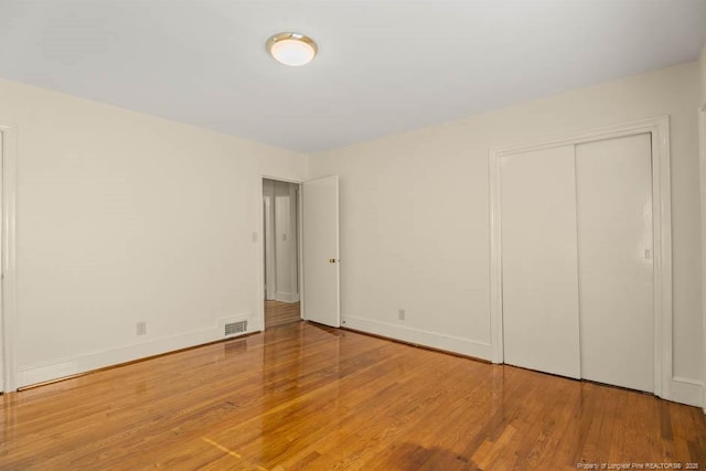 1905 N Rowland Ave N, Lumberton, NC 28358 - unfurnished bedroom with wood finished floors and a closet