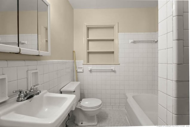 1905 N Rowland Ave N, Lumberton, NC 28358 - bathroom featuring tile walls, a tub, tile patterned flooring, and a wainscoted wall