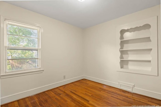 1905 N Rowland Ave N, Lumberton, NC 28358 - spare room with wood finished floors and baseboards