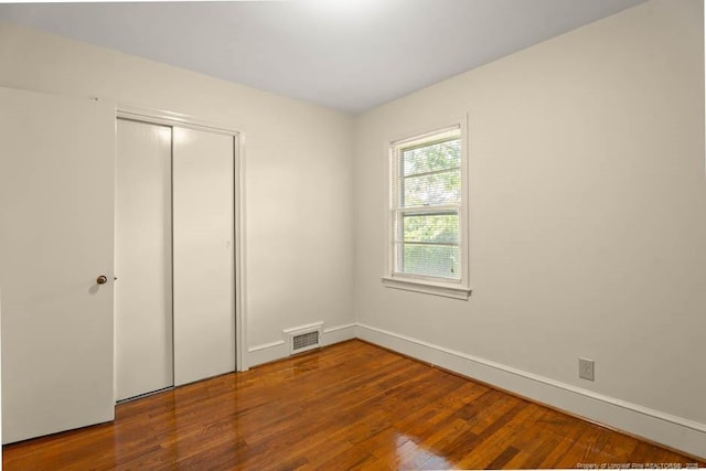 1905 N Rowland Ave N, Lumberton, NC 28358 - unfurnished bedroom featuring wood finished floors and a closet