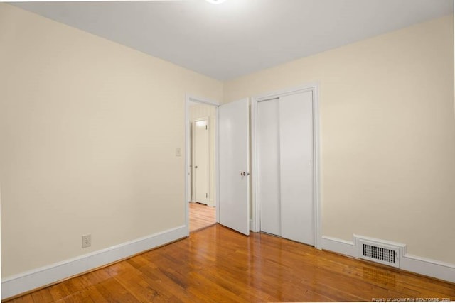 1905 N Rowland Ave N, Lumberton, NC 28358 - unfurnished bedroom with wood finished floors and a closet
