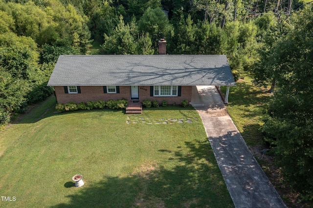 3603 Grimes Ave, Durham, NC 27703 - single story home featuring a chimney, concrete driveway, a front lawn, an attached carport, and a forest view