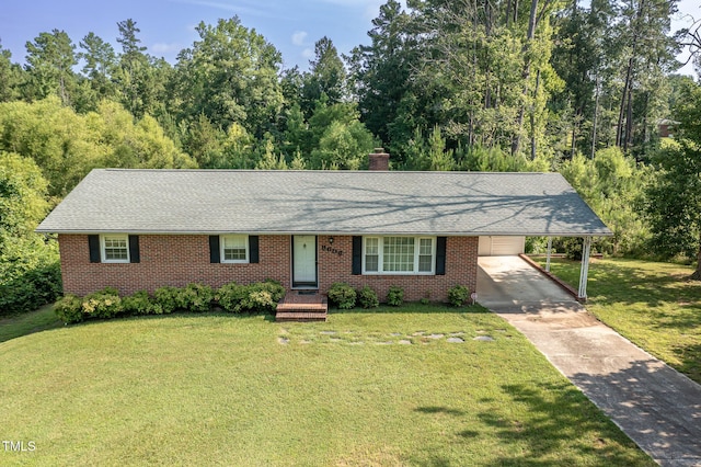3603 Grimes Ave, Durham, NC 27703 - ranch-style house featuring driveway, a chimney, a front yard, an attached carport, and brick siding