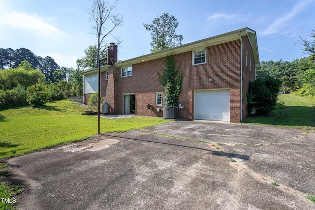 3603 Grimes Ave, Durham, NC 27703 - view of side of home featuring brick siding, driveway, and a lawn