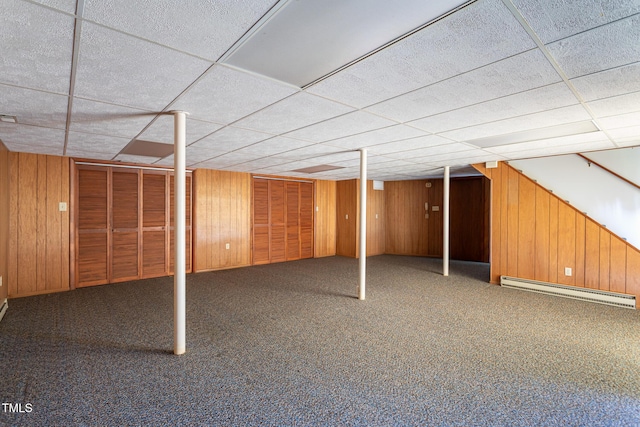 3603 Grimes Ave, Durham, NC 27703 - finished below grade area featuring a baseboard heating unit, wooden walls, a drop ceiling, and carpet