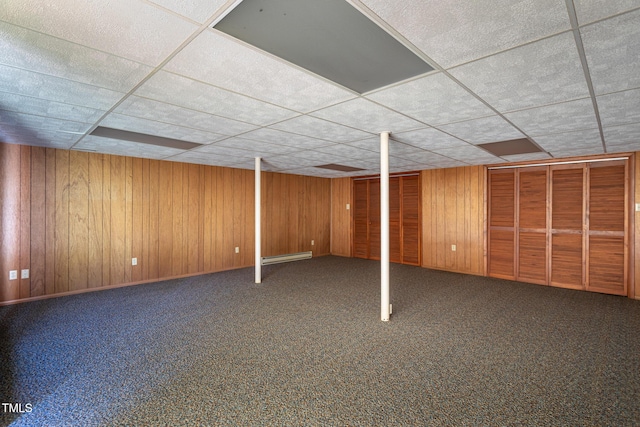 3603 Grimes Ave, Durham, NC 27703 - finished basement with a paneled ceiling, carpet floors, wood walls, and a baseboard radiator