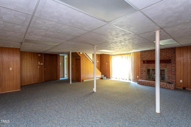 3603 Grimes Ave, Durham, NC 27703 - below grade area featuring wood walls, a fireplace, carpet flooring, and stairs