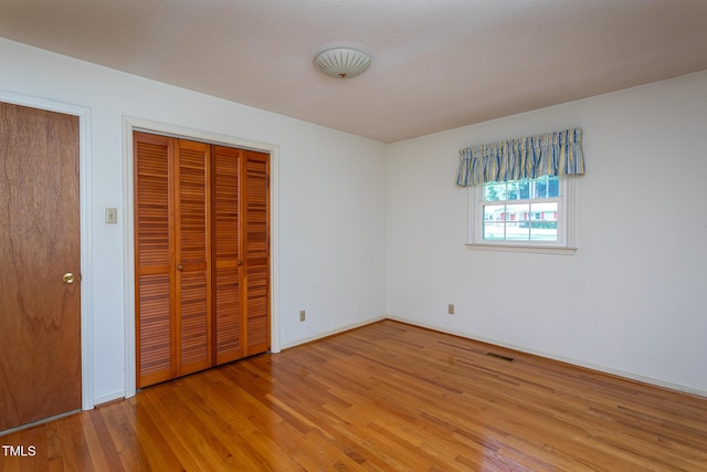 3603 Grimes Ave, Durham, NC 27703 - unfurnished bedroom featuring wood finished floors and a closet
