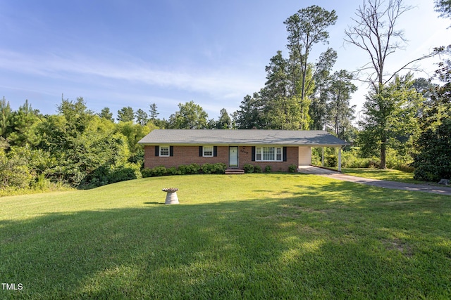 3603 Grimes Ave, Durham, NC 27703 - single story home with concrete driveway, brick siding, a front lawn, and an attached carport
