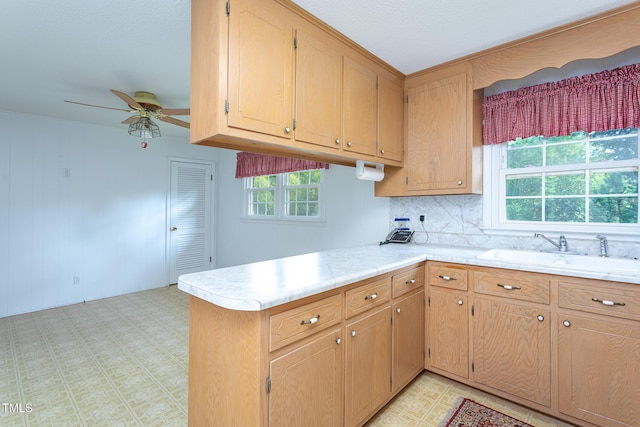 3603 Grimes Ave, Durham, NC 27703 - kitchen featuring light countertops, a peninsula, ceiling fan, and decorative backsplash