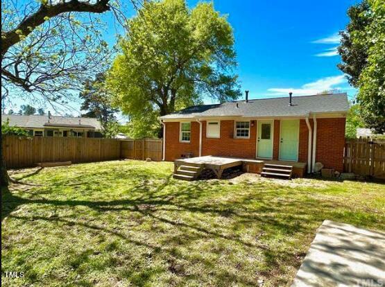 1206 Downing Rd, Raleigh, NC 27610 - back of property with a fenced backyard and brick siding