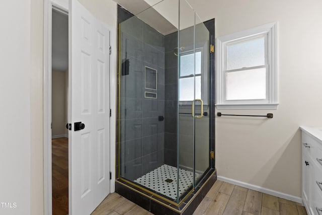 3421 Tunas St, Raleigh, NC 27616 - bathroom with vanity, a stall shower, and wood finished floors