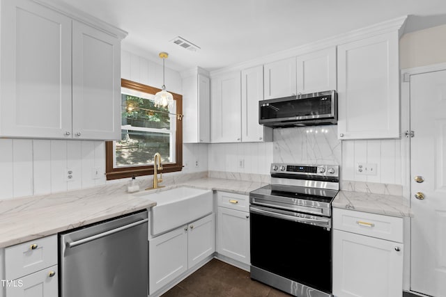 3421 Tunas St, Raleigh, NC 27616 - kitchen with stainless steel appliances, white cabinetry, decorative backsplash, hanging light fixtures, and light stone countertops