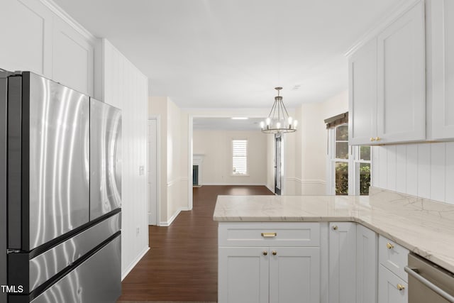 3421 Tunas St, Raleigh, NC 27616 - kitchen with appliances with stainless steel finishes, dark wood-type flooring, a peninsula, a chandelier, and white cabinets