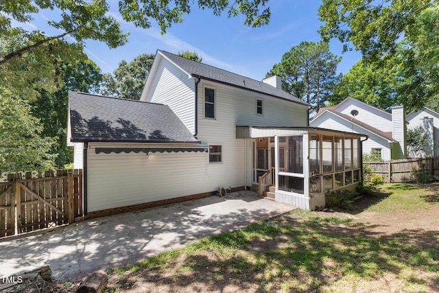3421 Tunas St, Raleigh, NC 27616 - rear view of house featuring a sunroom, a patio area, a chimney, and roof with shingles