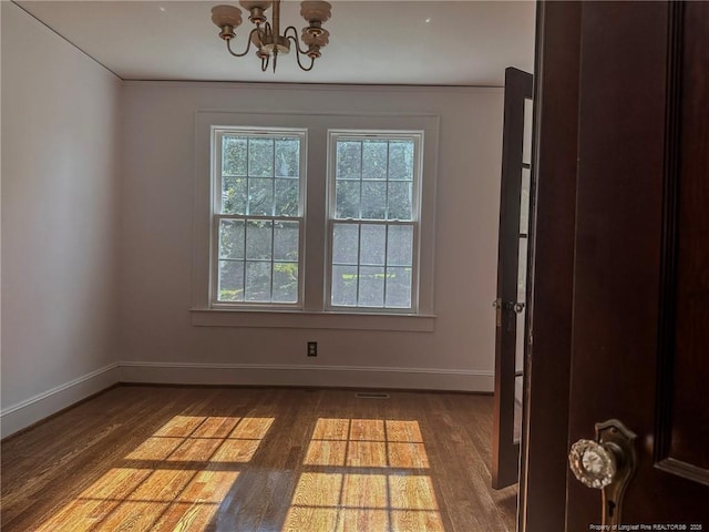 202 E 17th St, Lumberton, NC 28358 - unfurnished room with wood finished floors, a chandelier, and ornamental molding