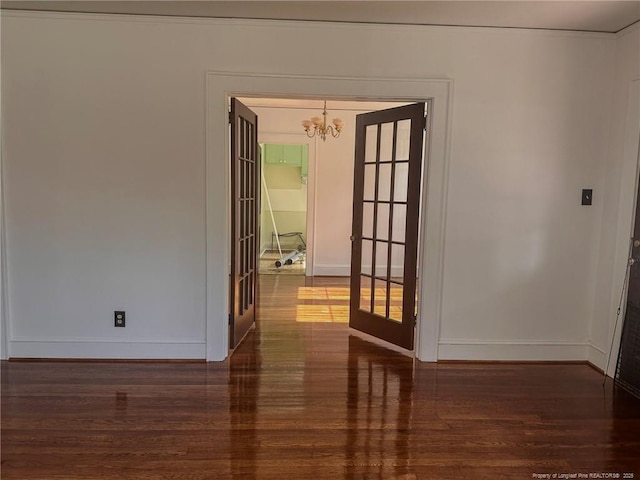 202 E 17th St, Lumberton, NC 28358 - unfurnished room featuring french doors, wood finished floors, and a chandelier