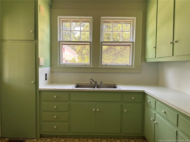 202 E 17th St, Lumberton, NC 28358 - kitchen with green cabinetry, healthy amount of natural light, and light countertops