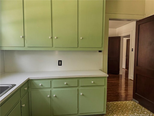 202 E 17th St, Lumberton, NC 28358 - kitchen featuring green cabinets, light countertops, and dark wood-type flooring