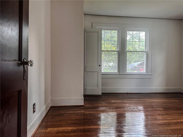 202 E 17th St, Lumberton, NC 28358 - unfurnished room featuring baseboards and dark wood-type flooring