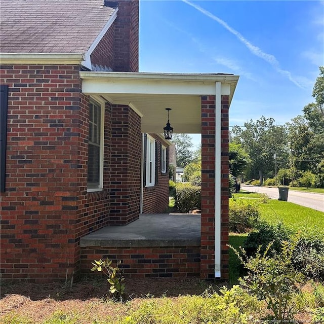 202 E 17th St, Lumberton, NC 28358 - view of home's exterior featuring brick siding and a chimney