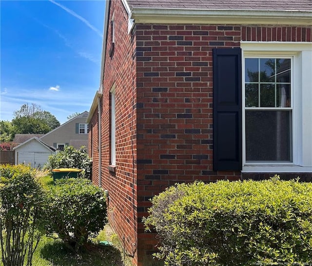 202 E 17th St, Lumberton, NC 28358 - exterior view of brick siding, gutters, a downspout, and a shingled roof