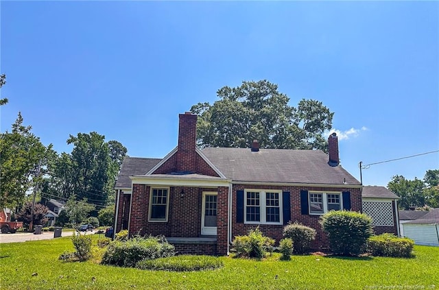 202 E 17th St, Lumberton, NC 28358 - view of front of property featuring a front lawn, brick siding, and a chimney