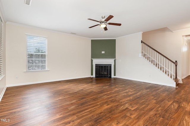 713 Summer Music Ln, Raleigh, NC 27603 - unfurnished living room with stairs, ornamental molding, wood finished floors, a ceiling fan, and a fireplace with flush hearth