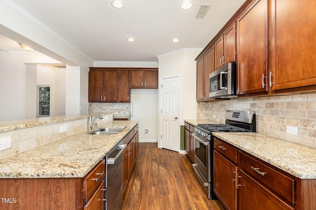 713 Summer Music Ln, Raleigh, NC 27603 - kitchen with stainless steel appliances, dark wood finished floors, light stone counters, backsplash, and recessed lighting