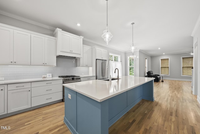 733 Daniel Ridge Rd, Wendell, NC 27591 - kitchen with premium appliances, ornamental molding, recessed lighting, light wood-style flooring, and an island with sink