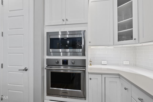 733 Daniel Ridge Rd, Wendell, NC 27591 - kitchen featuring stainless steel appliances, white cabinets, and tasteful backsplash
