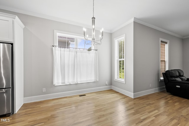 733 Daniel Ridge Rd, Wendell, NC 27591 - unfurnished dining area featuring light wood finished floors, a chandelier, and crown molding