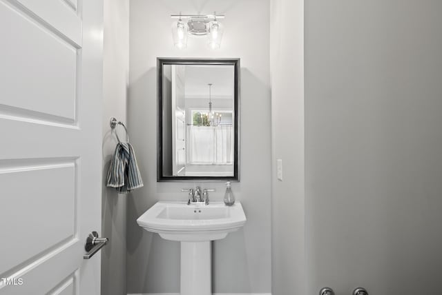 733 Daniel Ridge Rd, Wendell, NC 27591 - bathroom with a chandelier and a sink