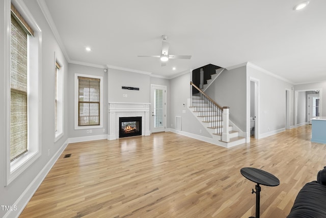 733 Daniel Ridge Rd, Wendell, NC 27591 - unfurnished living room featuring plenty of natural light, light wood-style floors, stairway, a ceiling fan, and recessed lighting