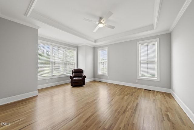 733 Daniel Ridge Rd, Wendell, NC 27591 - unfurnished room with a raised ceiling, ornamental molding, light wood-style flooring, and a ceiling fan
