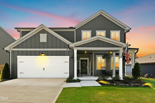 444 Campbell Ridge Pl, Wendell, NC 27591 - view of front facade featuring board and batten siding, a front lawn, concrete driveway, a porch, and an attached garage