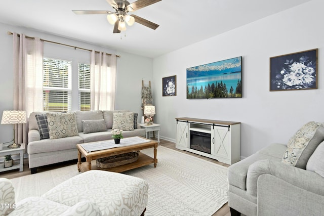 444 Campbell Ridge Pl, Wendell, NC 27591 - living area with wood finished floors, a ceiling fan, and a fireplace