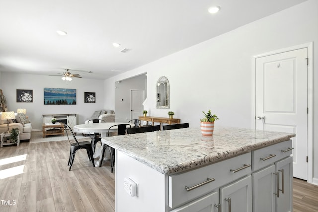 444 Campbell Ridge Pl, Wendell, NC 27591 - kitchen with a ceiling fan, light wood finished floors, open floor plan, a center island, and recessed lighting