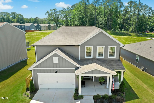 444 Campbell Ridge Pl, Wendell, NC 27591 - view of front of home featuring board and batten siding, roof with shingles, a front yard, and a garage
