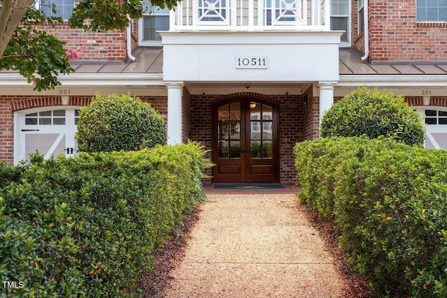 10511 Rosegate Ct Unit 103, Raleigh, NC 27617 - entrance to property with french doors, brick siding, and a standing seam roof