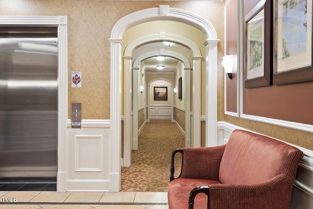 10511 Rosegate Ct Unit 103, Raleigh, NC 27617 - corridor with elevator, tile patterned floors, arched walkways, wainscoting, and wallpapered walls