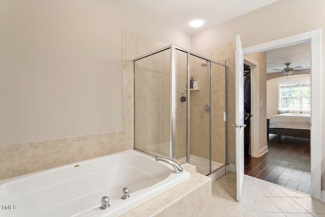 10511 Rosegate Ct Unit 103, Raleigh, NC 27617 - ensuite bathroom with a bath, a ceiling fan, a shower stall, and tile patterned flooring