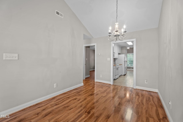 3782 Loblolly Dr # 5, Rocky Mount, NC 27804 - unfurnished dining area with a chandelier, wood finished floors, and vaulted ceiling