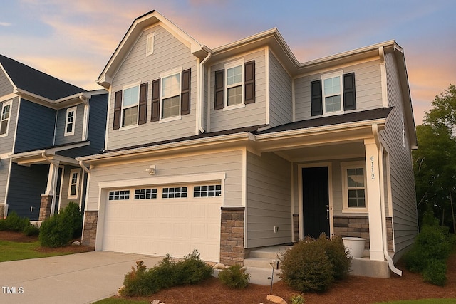 6112 Balance Ct, Raleigh, NC 27616 - view of front of house with an attached garage, stone siding, concrete driveway, and covered porch