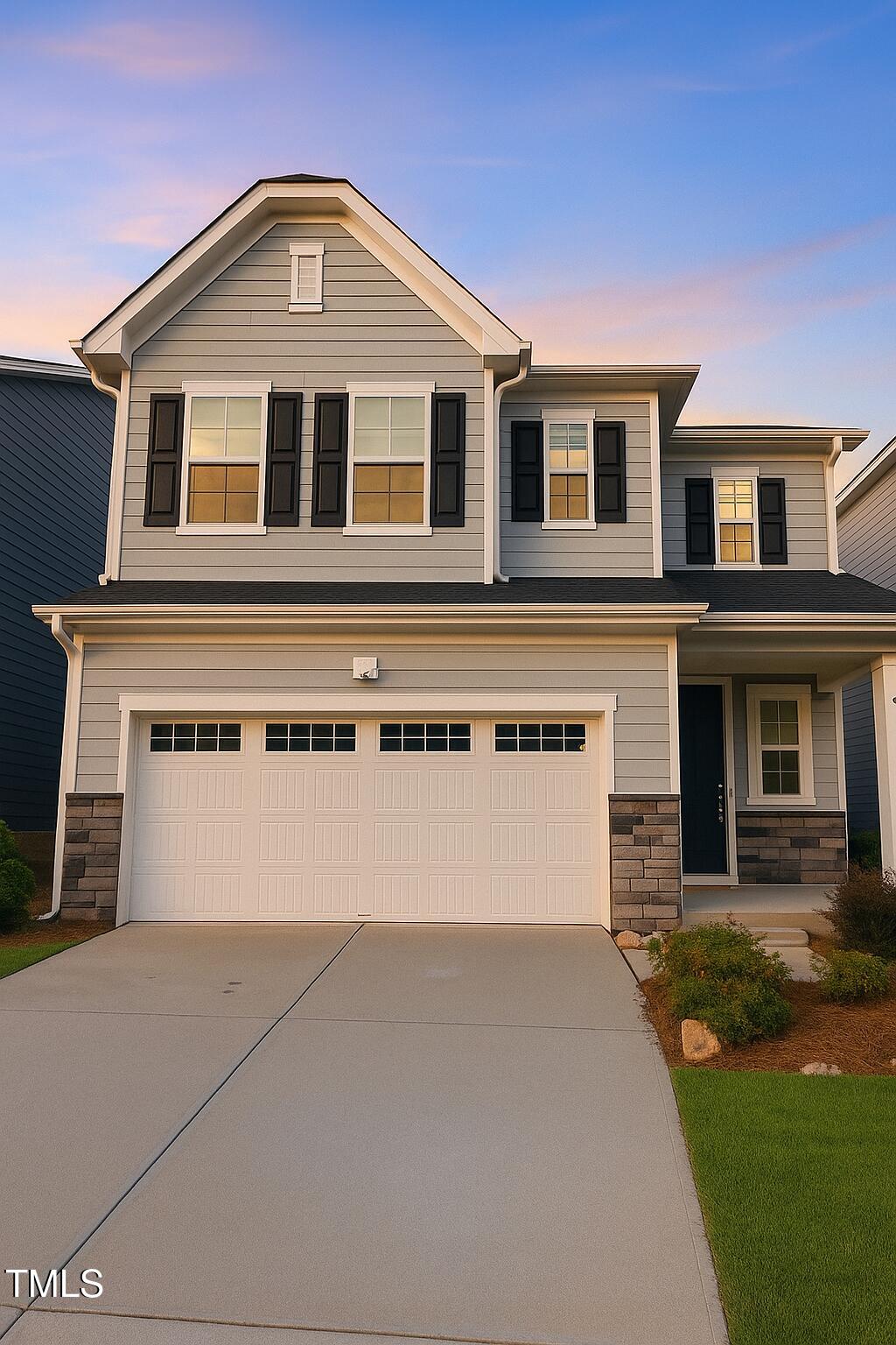6112 Balance Ct, Raleigh, NC 27616 - view of front facade with a garage, stone siding, and driveway